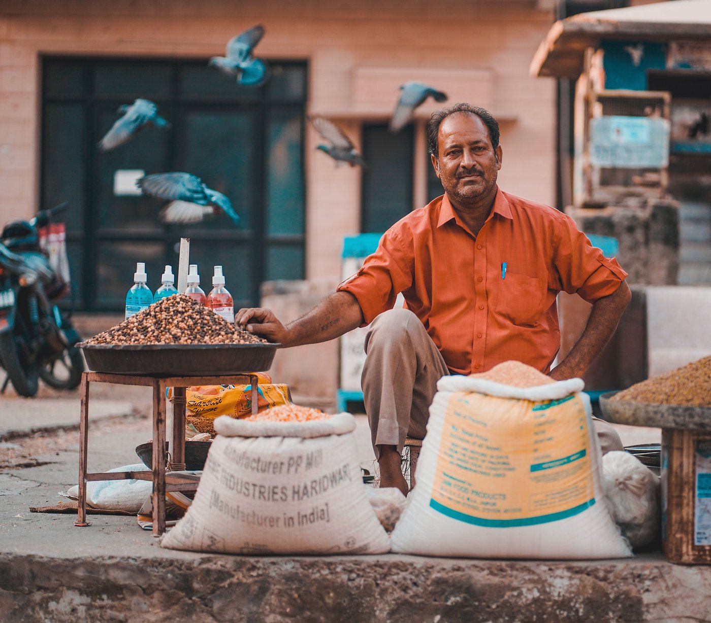 A street vendor selling grains and spices at a local market